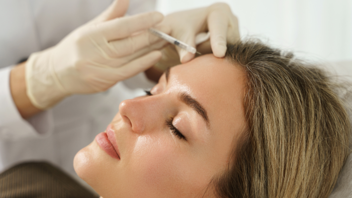 A woman receiving Profhilo treatment with focus on rejuvenated skin.