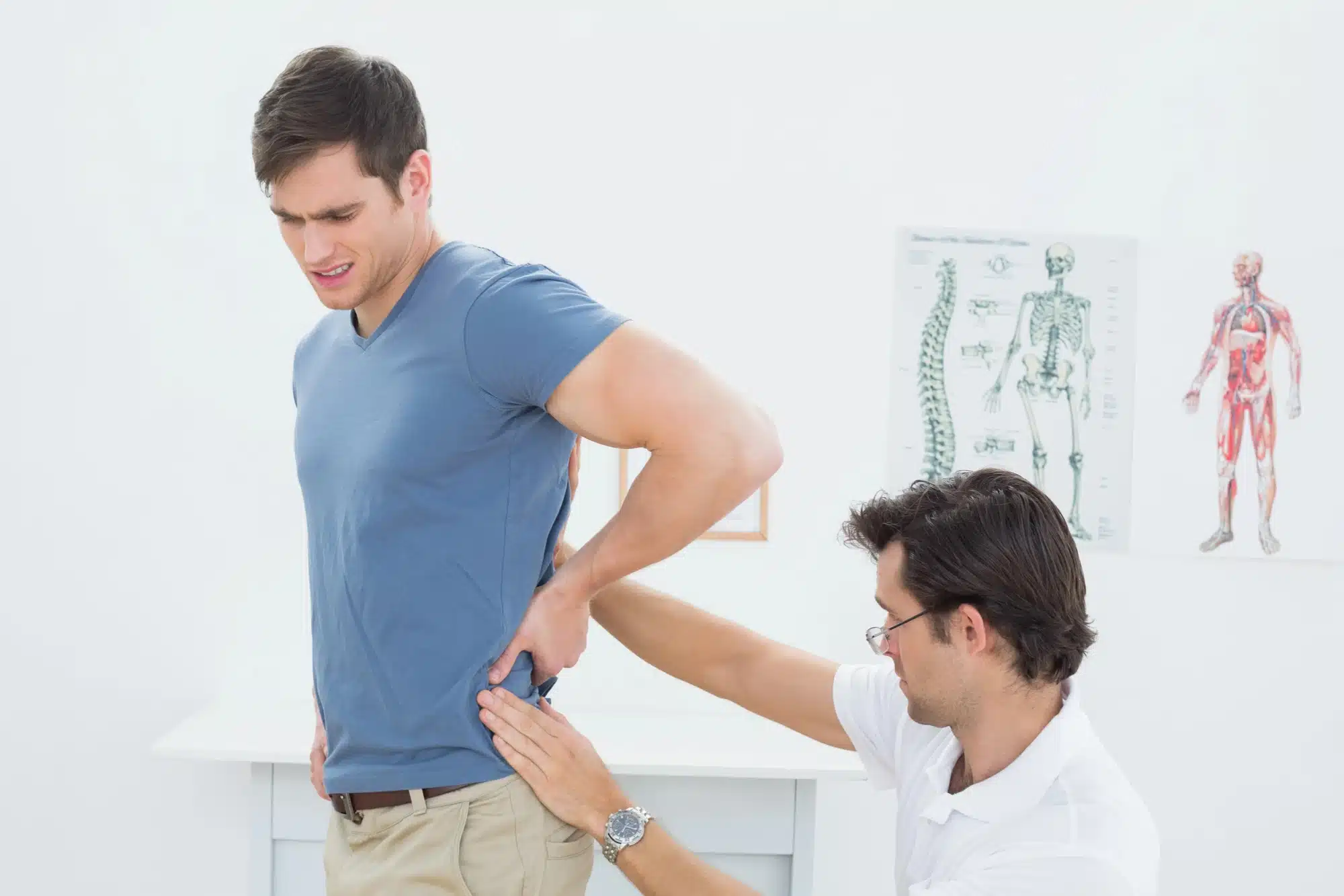 man at doctor, before getting hip injection for pain relief