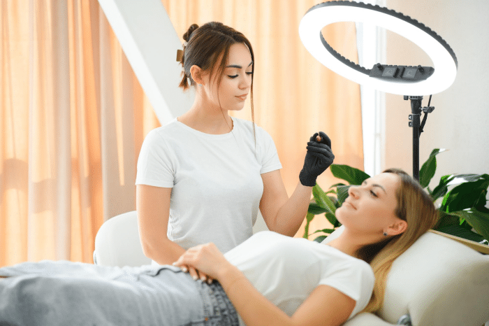 Aesthetician preparing to apply Dermalax filler on a client in a clinical setting, showcasing the professional environment and care involved in the dermal filler process"