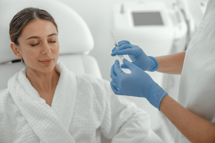 Beautiful healthy smiling caucasian woman is getting a Dermalax fillers procedure
