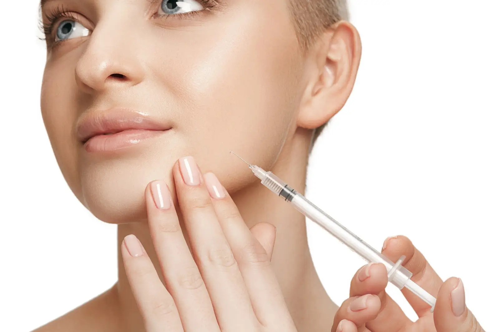 Close-up of a person with light skin, touching their cheek with one hand while holding a syringe with the other. The background is plain white, and the focus is on the face and the syringe.